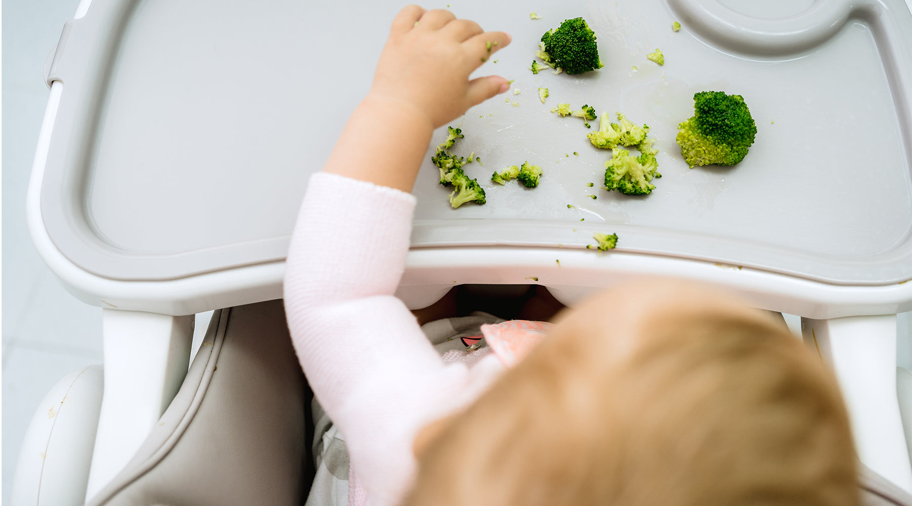 best baby snacks for 6 month olds, child eating broccoli