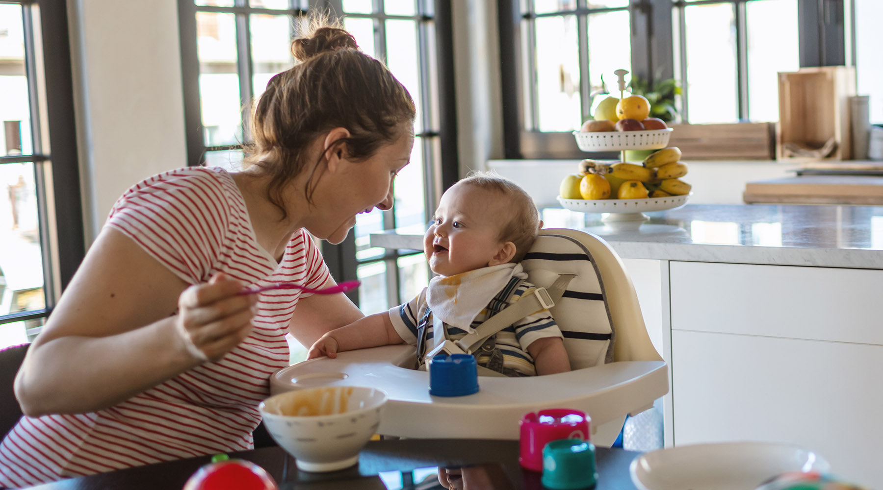 mother feeding baby food allergens